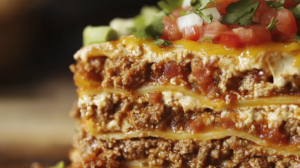 Unlike traditional lasagna, where layers are defined by pasta, ricotta cheese, and marinara, taco lasagna features tortillas as the base, giving it a Tex-Mex flair